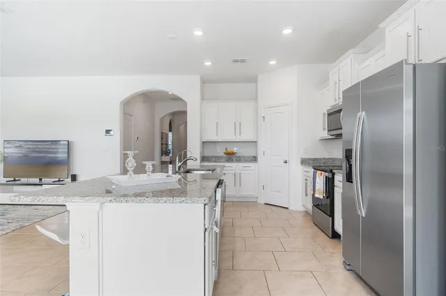 a kitchen with granite countertop a sink and cabinets