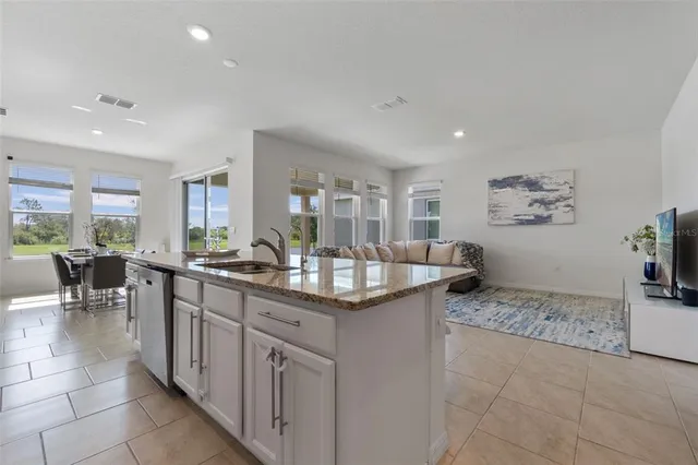 a dining room with furniture and a floor to ceiling window