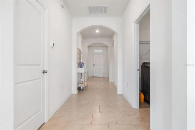a bedroom with furniture and a flat screen tv