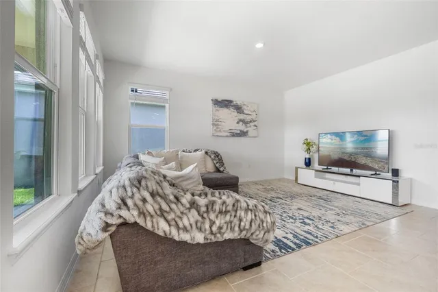 a living room with furniture window and a flat screen tv