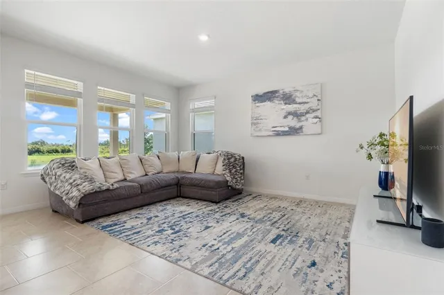 a living room with furniture and a large window