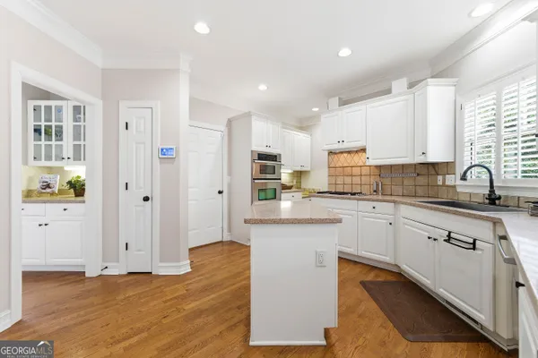 a kitchen with stainless steel appliances granite countertop a sink and cabinets
