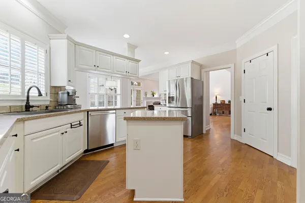 a kitchen with stainless steel appliances granite countertop a sink stove and cabinets