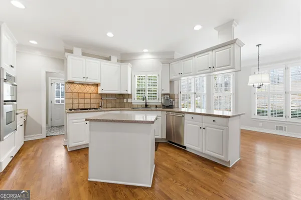 a utility room with cabinets washer and dryer