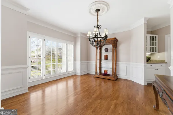 a living room with furniture a rug and a book shelf