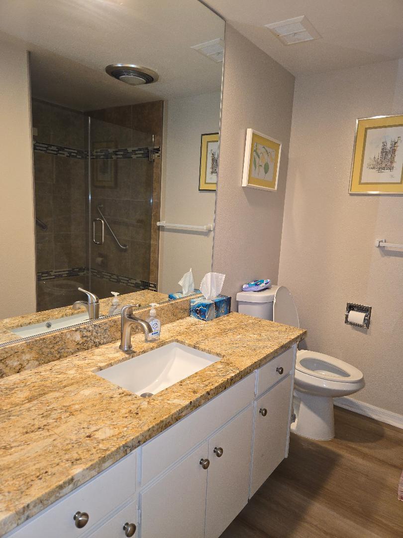 899 Island Drive, Unit 110 Rancho Mirage, CA 92270 - Photo 12 of 12 a bathroom with a granite countertop sink and a mirror