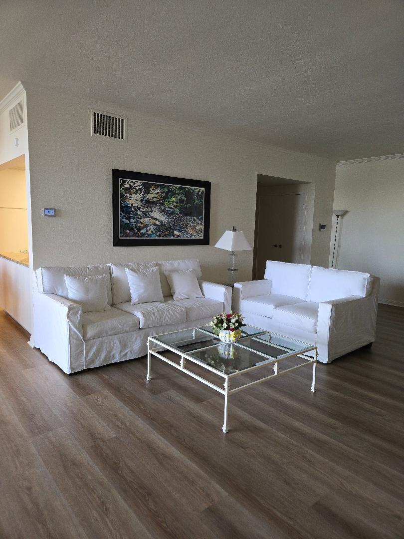 899 Island Drive, Unit 110 Rancho Mirage, CA 92270 - Photo 6 of 12 a living room with furniture and wooden floor