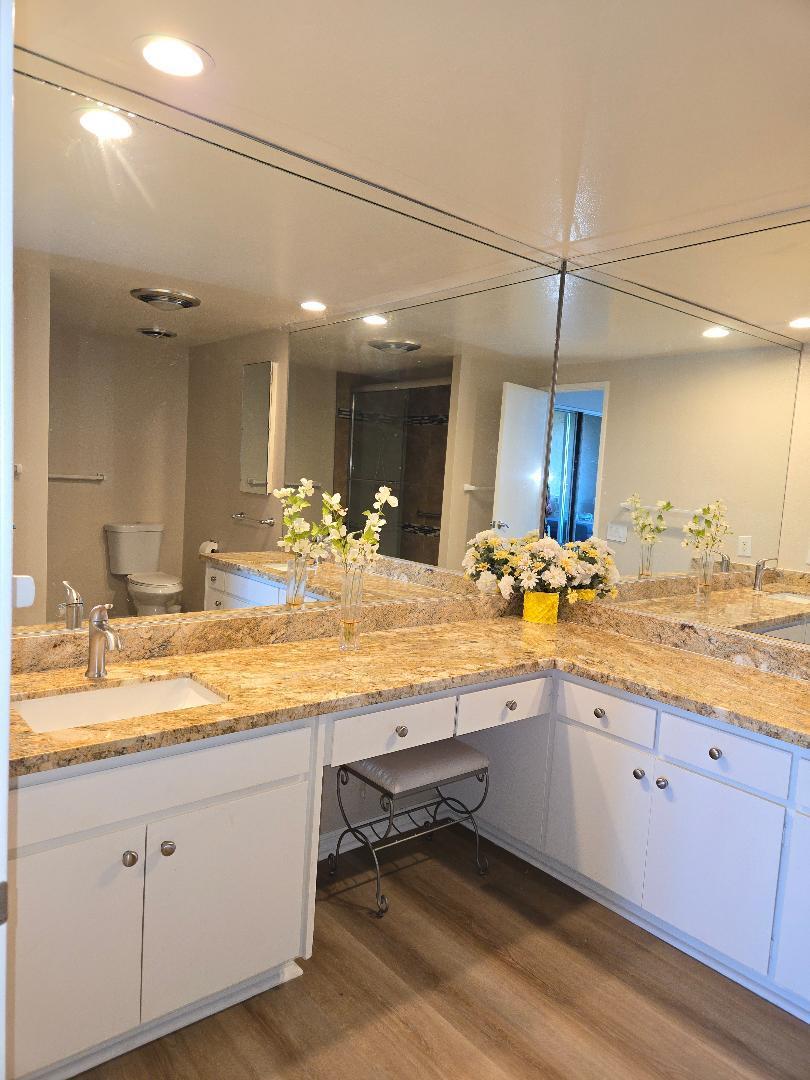 899 Island Drive, Unit 110 Rancho Mirage, CA 92270 - Photo 10 of 12 a bathroom with a sink double vanity and a mirror