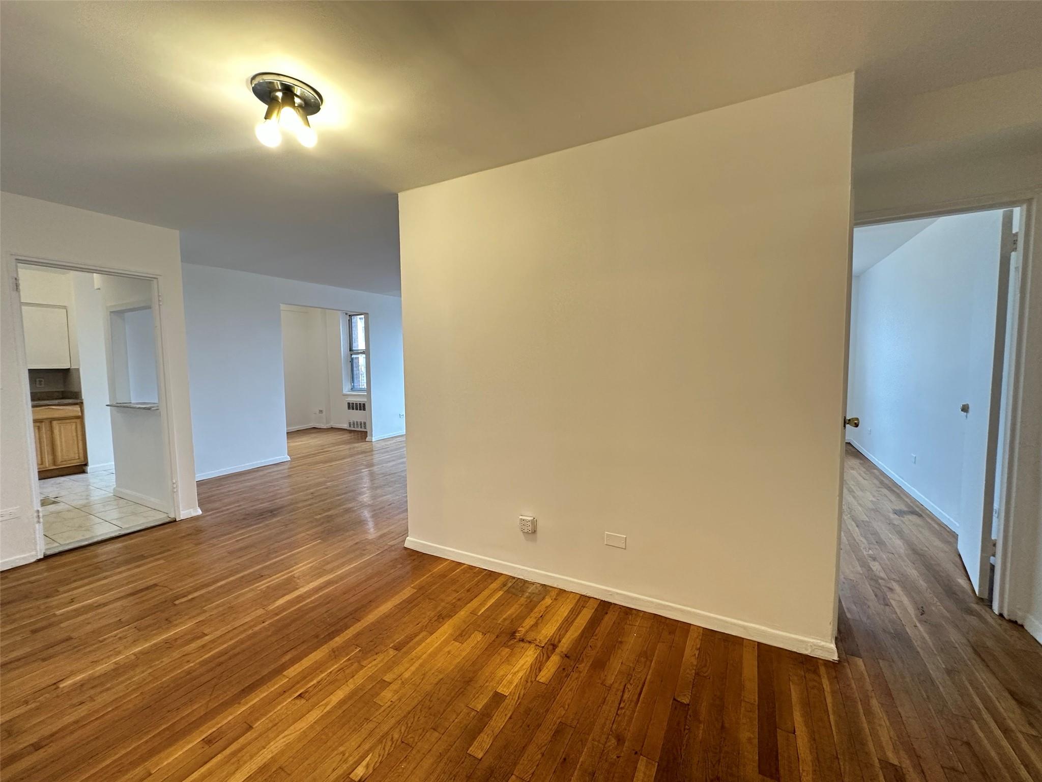 152-72 Melbourne Avenue, Unit 2P Queens, NY 11367 - Photo 4 of 8 Empty room featuring wood finished floors