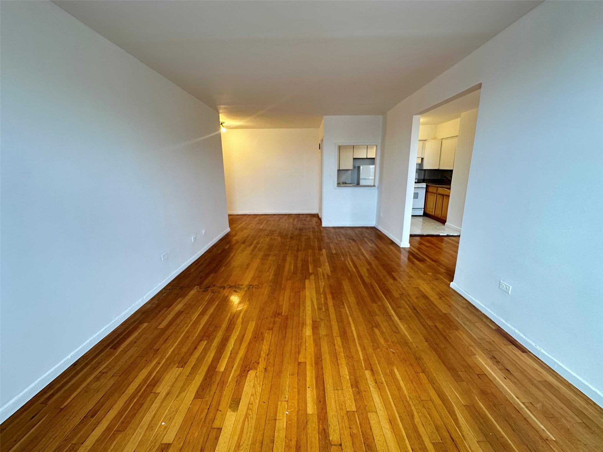 152-72 Melbourne Avenue, Unit 2P Queens, NY 11367 - Photo 8 of 8 Unfurnished living room featuring wood-type flooring