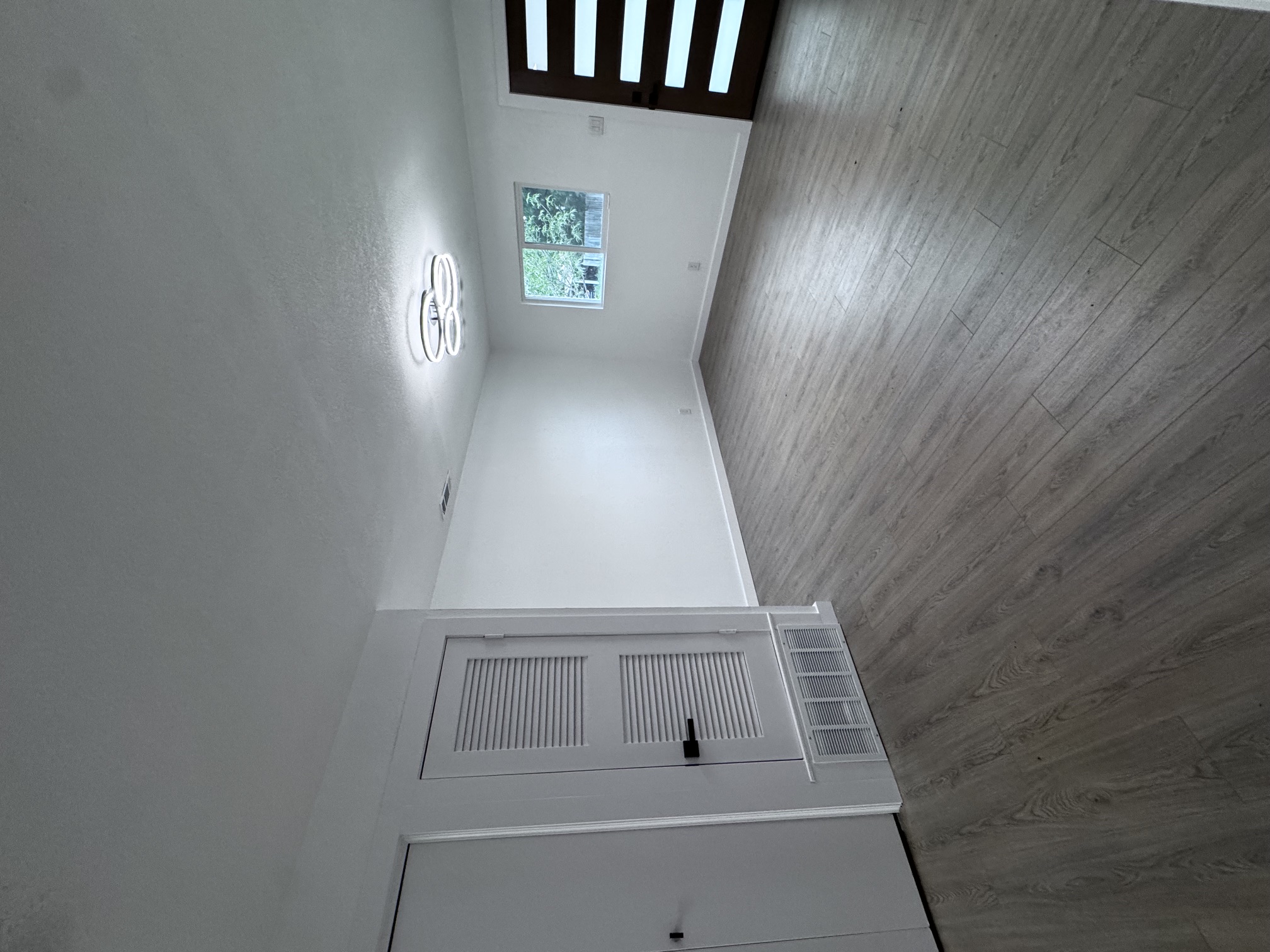 4908 Hawk Cove, Unit 2 Austin, TX 78745 - Photo 4 of 17 an empty room with wooden floor and windows