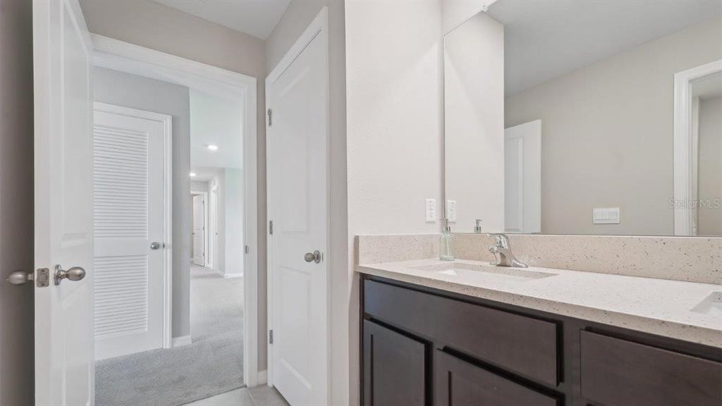 17563 Acorn Drop Road Land O Lakes, FL 34638 - Photo 18 of 23 a bathroom with a sink and a mirror