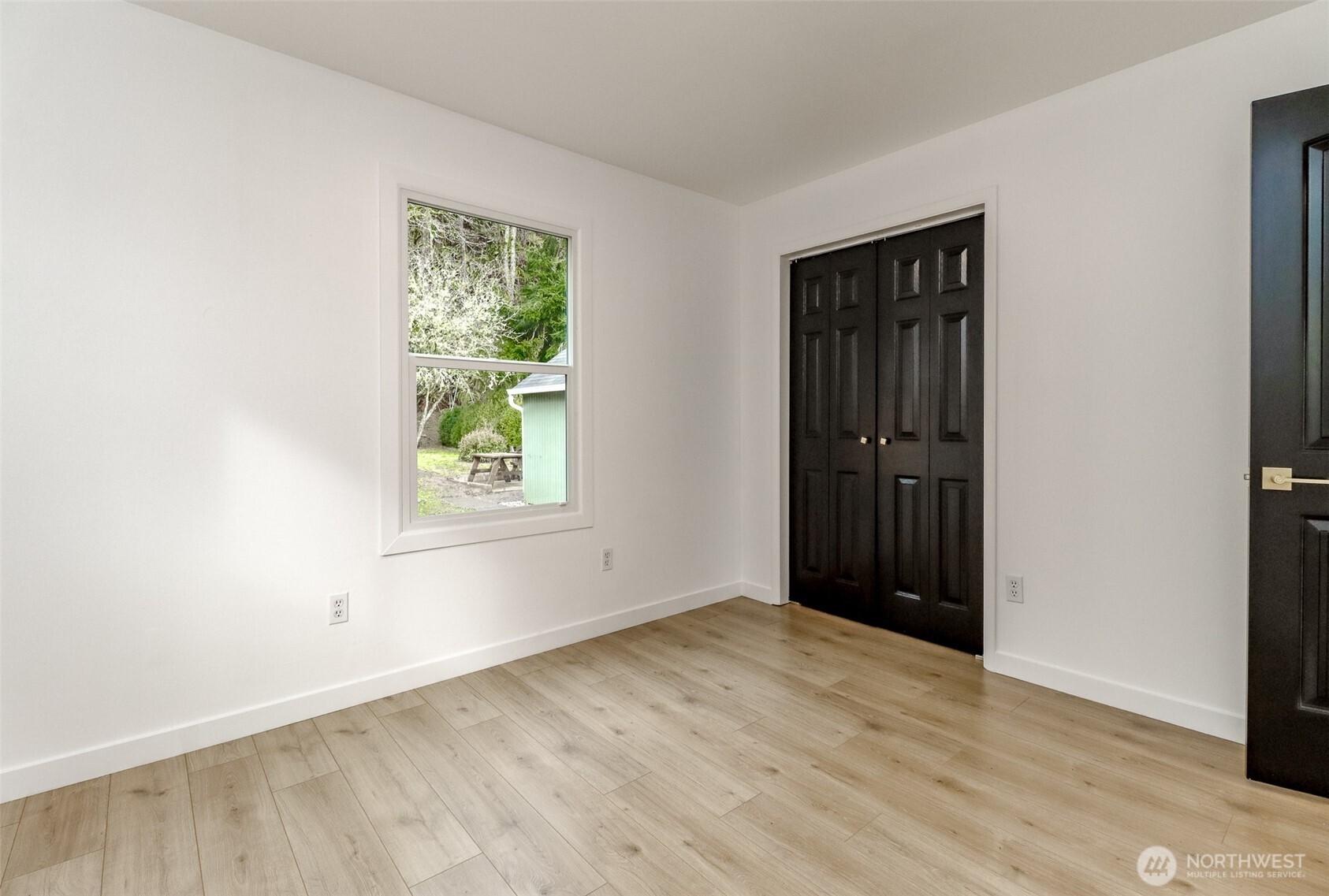 2115 Cherry Street Hoquiam, WA 98550 - Photo 13 of 31 a view of an empty room with wooden floor and a window