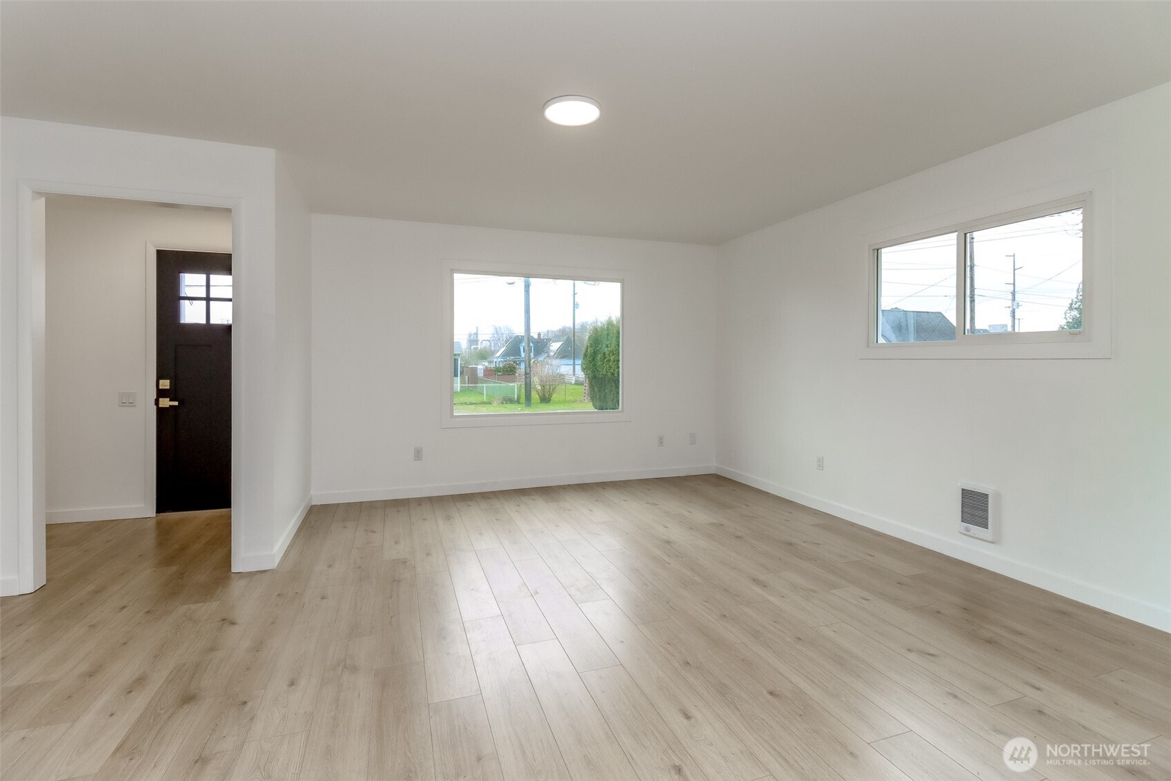 2115 Cherry Street Hoquiam, WA 98550 - Photo 5 of 31 an empty room with wooden floor and windows
