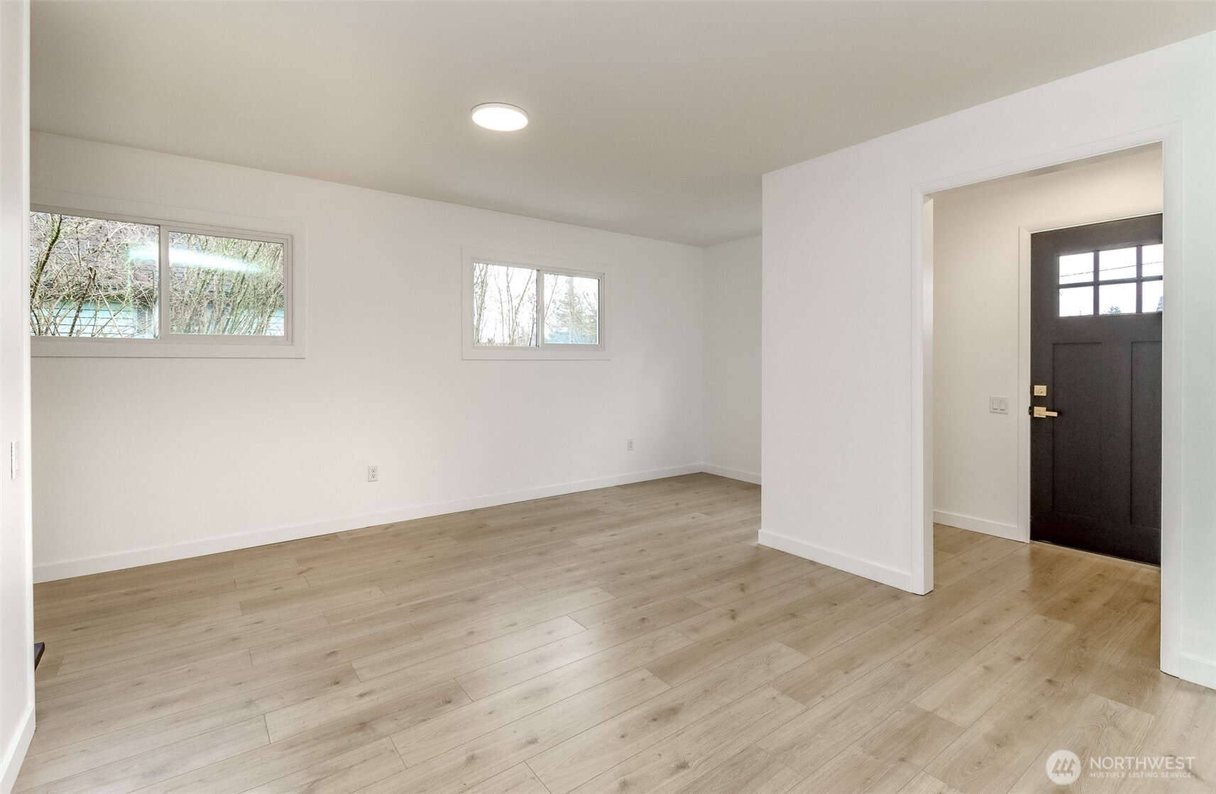 2115 Cherry Street Hoquiam, WA 98550 - Photo 7 of 31 an empty room with wooden floor and windows
