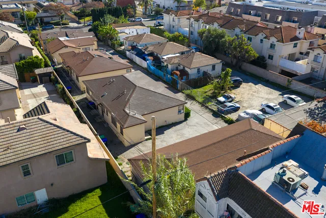 an aerial view of a residential houses with yard
