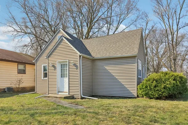 a view of a house with a yard and garage