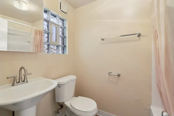a bathroom with a sink mirror and toilet