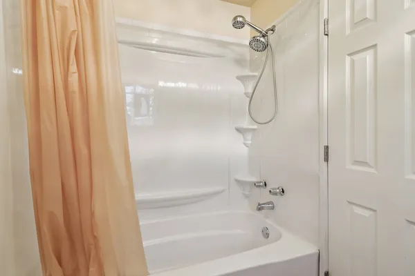 a bathroom with a bath tub and shower