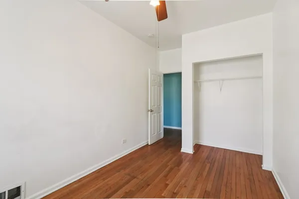 a view of a room with wooden floor