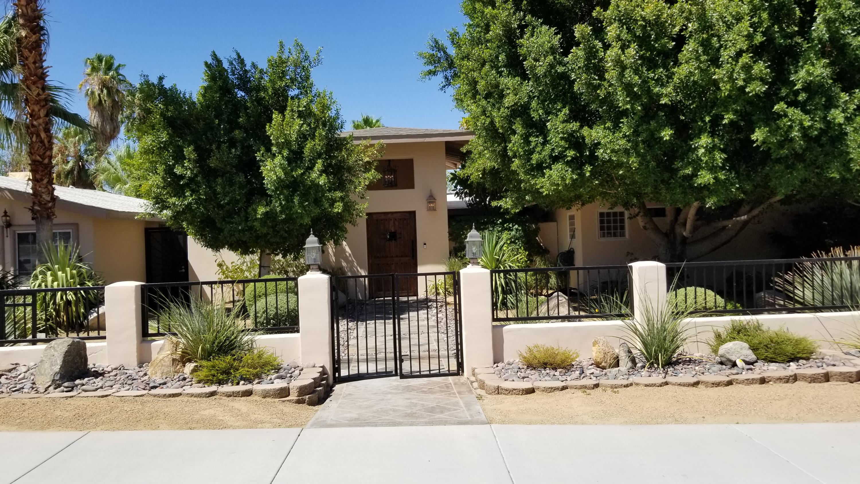 68446 Terrace Road Cathedral City, CA 92234 - Photo 1 of 81 a front view of a house with a garden and plants