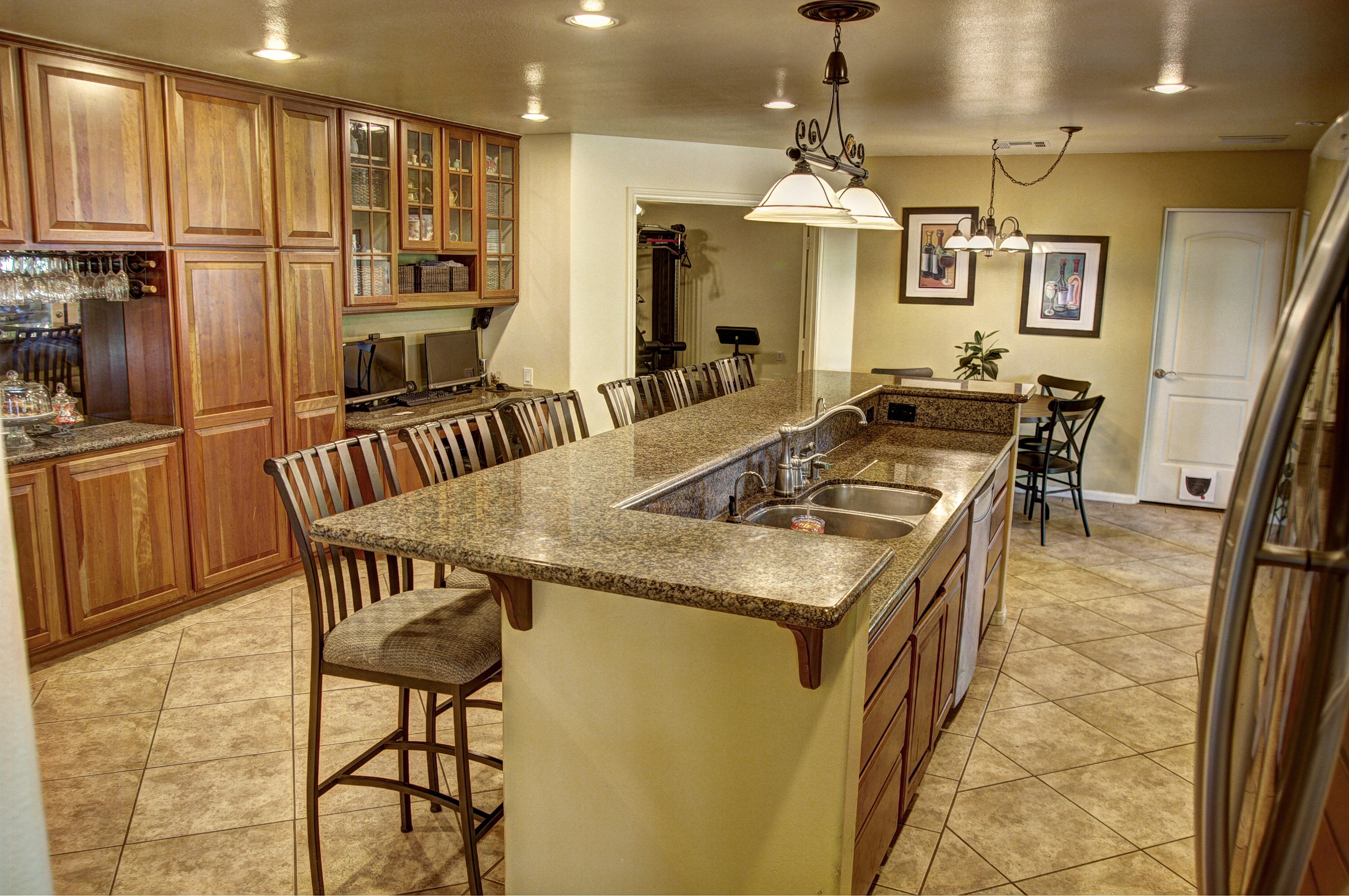 68446 Terrace Road Cathedral City, CA 92234 - Photo 19 of 81 a kitchen with stainless steel appliances granite countertop a stove top oven a sink dishwasher a dining table and chairs with wooden floor