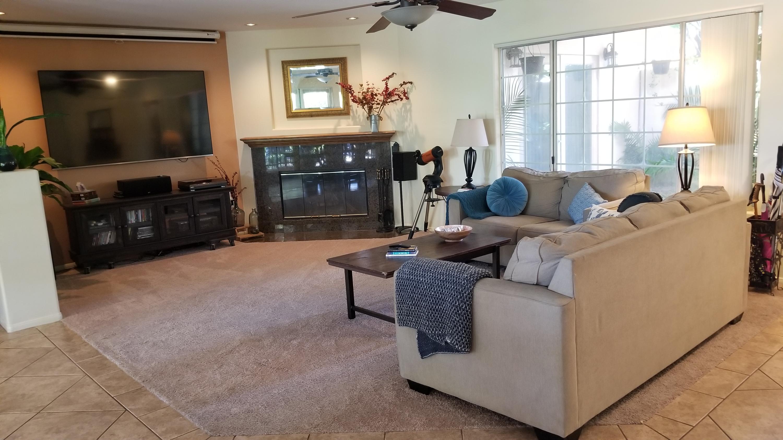 68446 Terrace Road Cathedral City, CA 92234 - Photo 4 of 81 a living room with furniture a flat screen tv and a fireplace