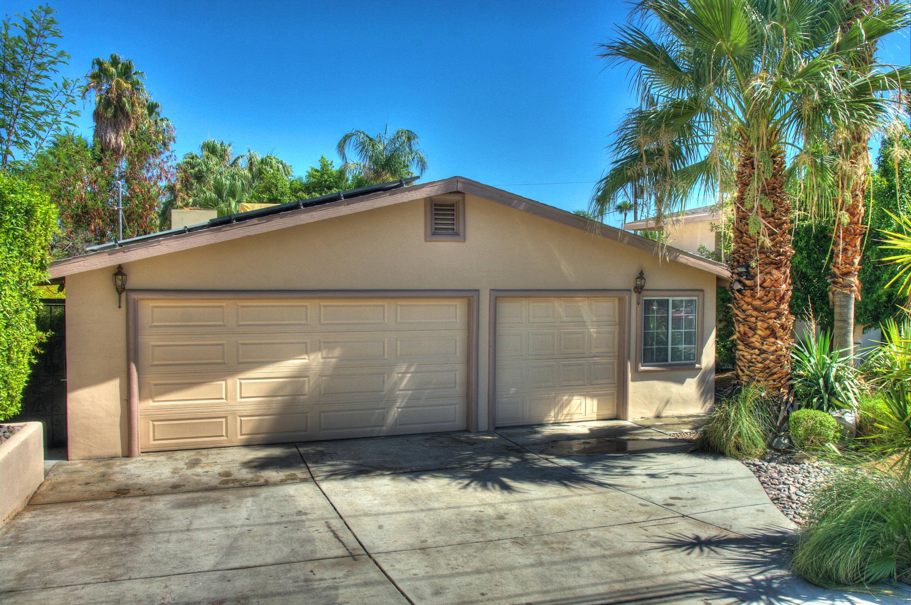 68446 Terrace Road Cathedral City, CA 92234 - Photo 50 of 81 a front view of a house with a yard and garage