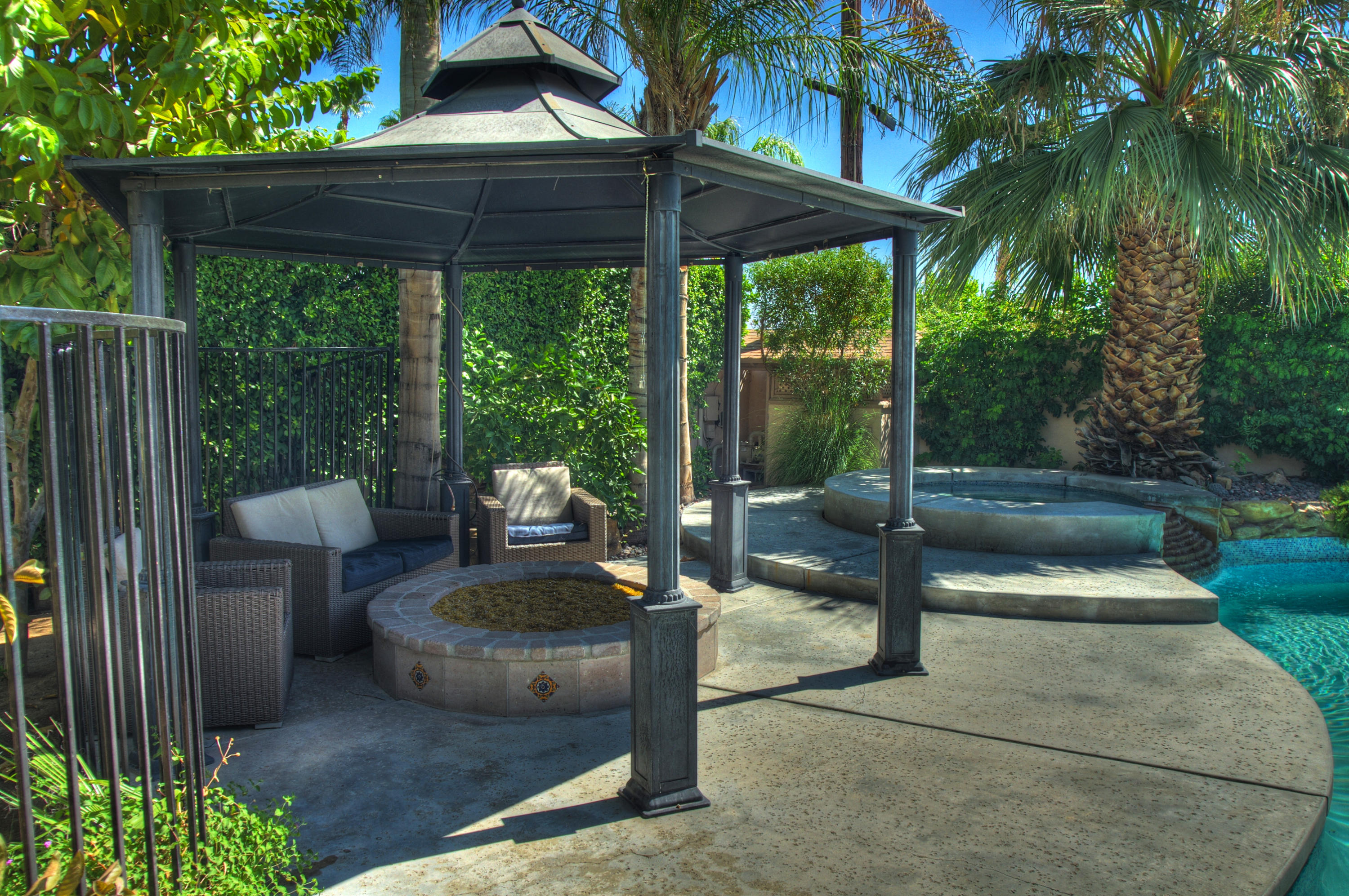 68446 Terrace Road Cathedral City, CA 92234 - Photo 66 of 81 a view of a patio with a table chairs and a floor to ceiling window with wooden fence