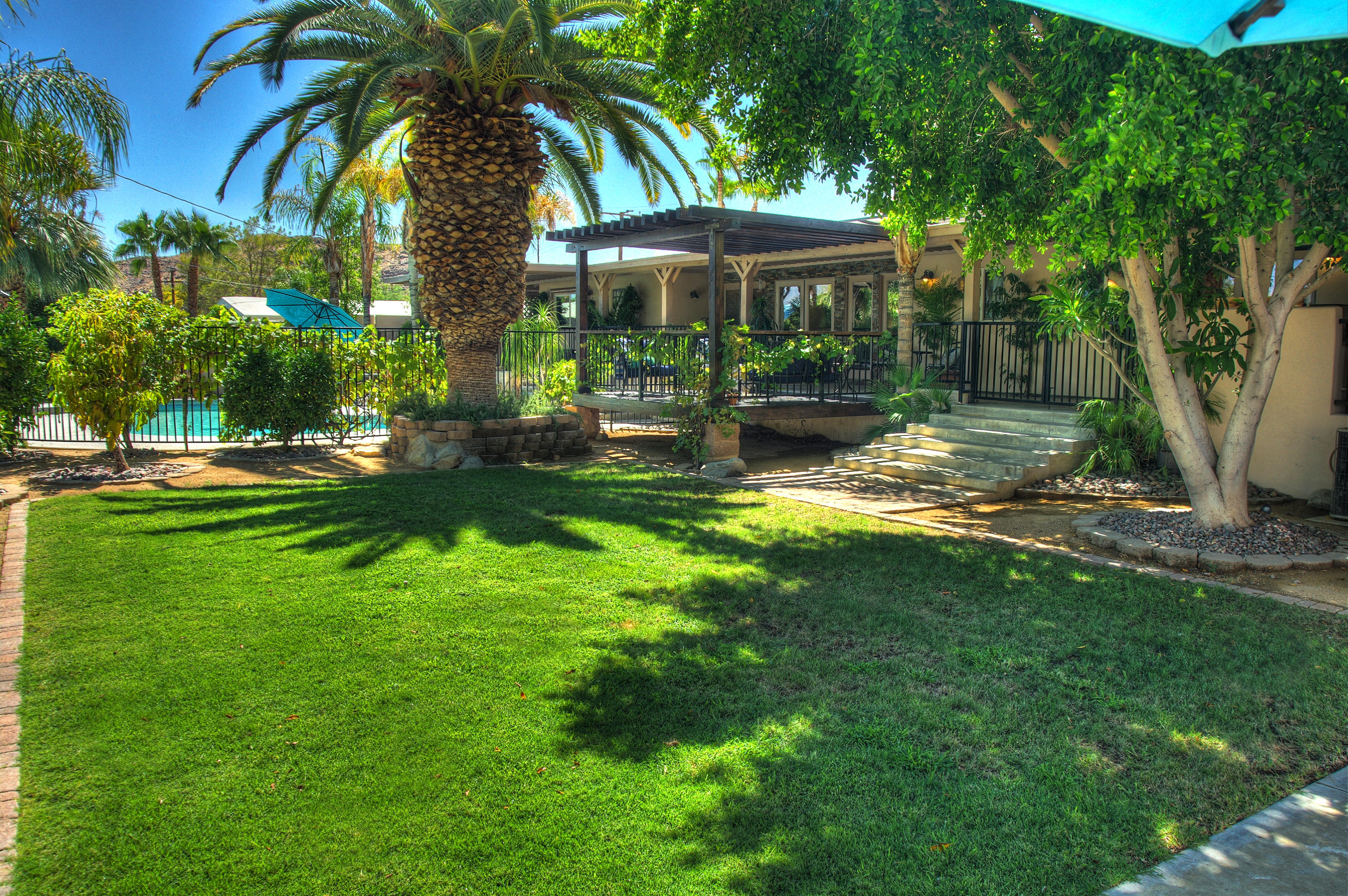 68446 Terrace Road Cathedral City, CA 92234 - Photo 77 of 81 a view of a yard with a table and chairs under an umbrella