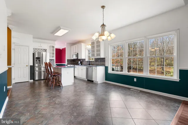 a view of a kitchen with microwave and cabinets
