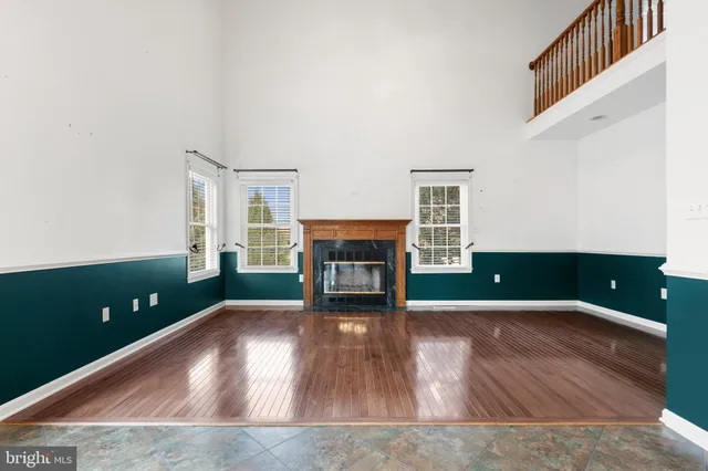 wooden floor in an empty room with a fireplace
