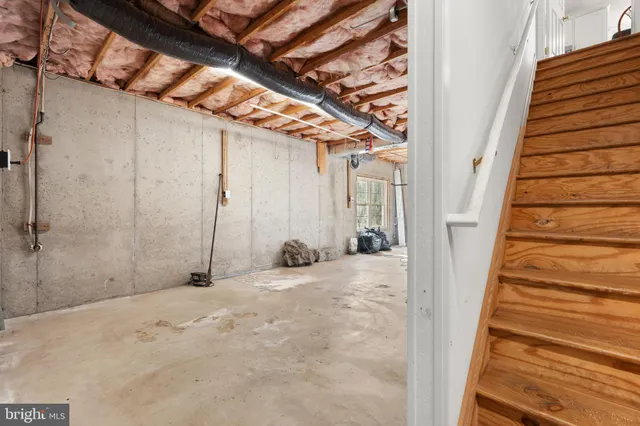 a view of a room with stairs and a wooden floor
