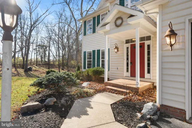 a view of a house with a yard and potted plants