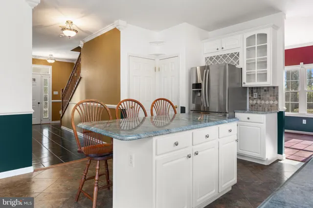 a kitchen with stainless steel appliances granite countertop a sink and a refrigerator