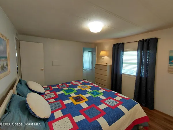 a bedroom with a bed and a lamp