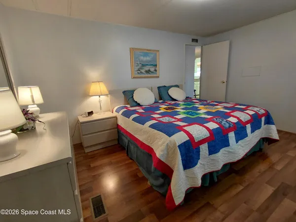 a bedroom with a bed and flat screen tv