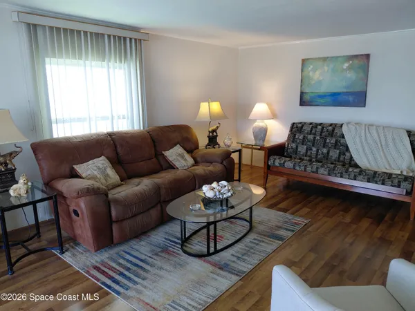 a living room with furniture lamp and window