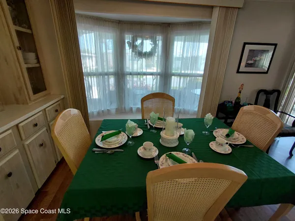 a view of a dining room with furniture and wooden floor