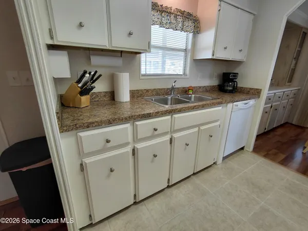a kitchen with a refrigerator and a sink