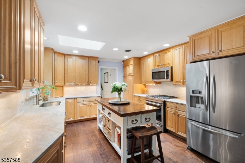 209 Lake Road Bernards, NJ 07920 - Photo 11 of 40 a kitchen with stainless steel appliances granite countertop a stove a sink a refrigerator and a microwave