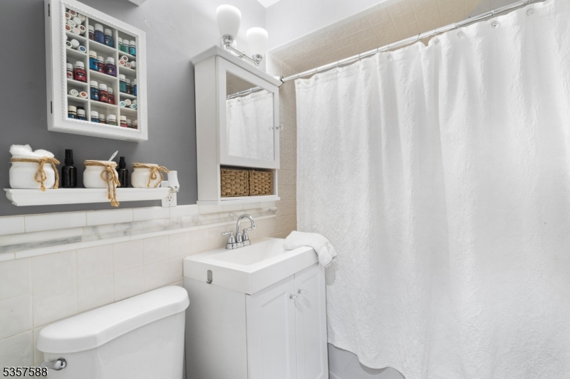 209 Lake Road Bernards, NJ 07920 - Photo 15 of 40 a bathroom with a sink a toilet and a mirror