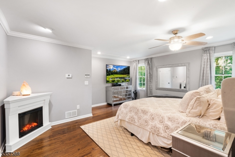 209 Lake Road Bernards, NJ 07920 - Photo 18 of 40 a bedroom with a bed and a fireplace