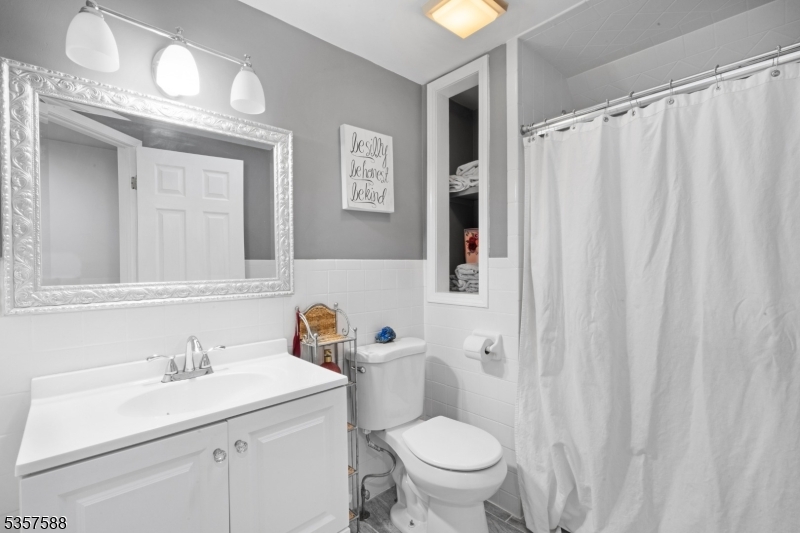 209 Lake Road Bernards, NJ 07920 - Photo 24 of 40 a bathroom with a sink a toilet and shower curtain