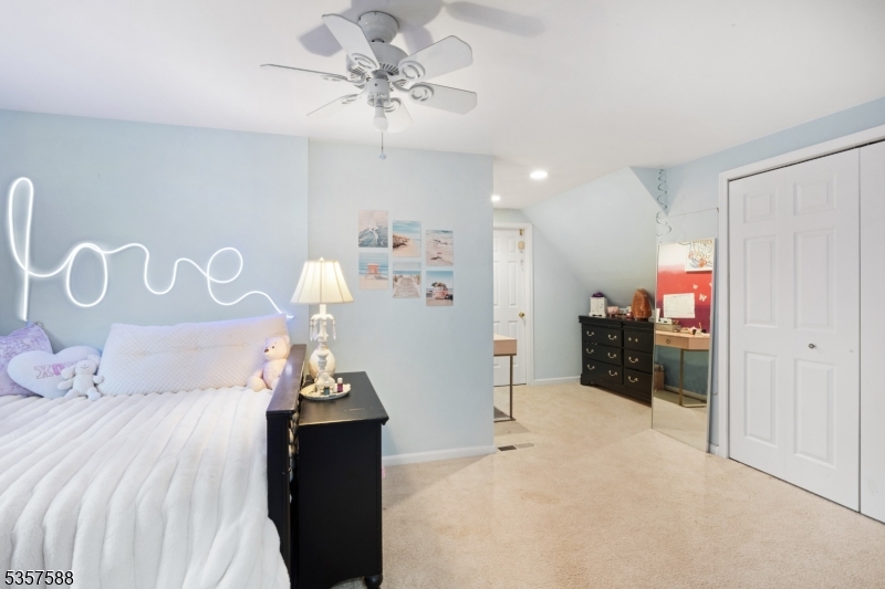 209 Lake Road Bernards, NJ 07920 - Photo 27 of 40 a bedroom with a bed and a chandelier