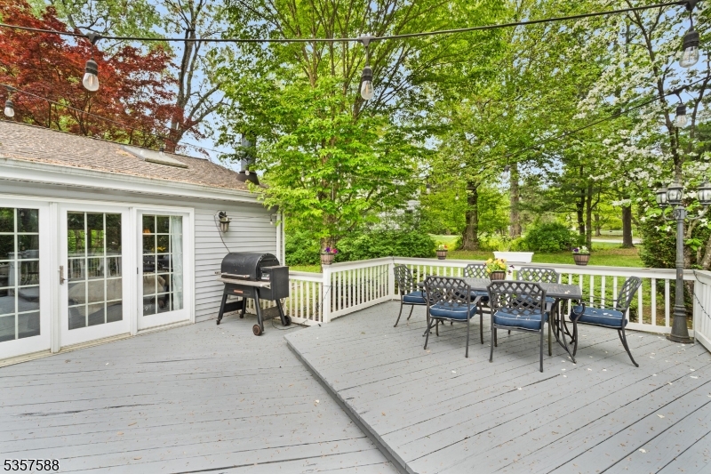 209 Lake Road Bernards, NJ 07920 - Photo 33 of 40 a view of a patio with a dining table and chairs with wooden floor and fence
