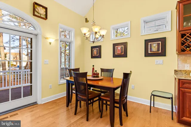 a view of a dining room with furniture and a chandelier