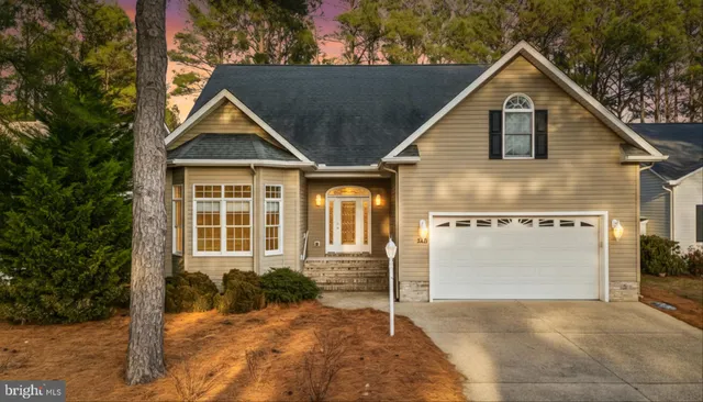 a view of a house with a yard and potted plants