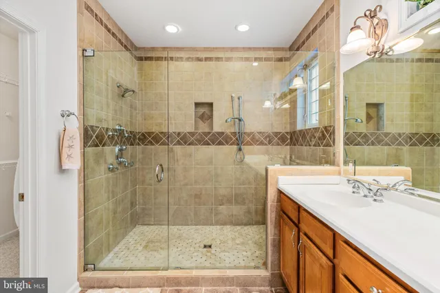 a bathroom with a shower sink and mirror