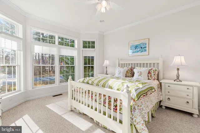 a bedroom with a bed and a large window